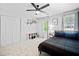 A well-lit bedroom with a ceiling fan, double door closet, and a comfortable bed at 815 Lake Forest Pass, Roswell, GA 30076