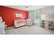 Bright Bedroom with a crib, comfortable chair, and colorful decor at 815 Lake Forest Pass, Roswell, GA 30076