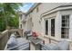 A view of the home's outdoor deck with patio furniture and french doors leading inside at 815 Lake Forest Pass, Roswell, GA 30076