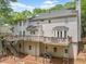 Expansive back view of the home featuring multi-level decks, neutral siding, and a large backyard at 815 Lake Forest Pass, Roswell, GA 30076