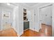 Hallway with hardwood floors and a view of a built-in wet bar and the front door at 815 Lake Forest Pass, Roswell, GA 30076