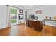 Bright home office with hardwood floors, two large windows and a large wooden desk at 815 Lake Forest Pass, Roswell, GA 30076