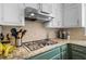 Kitchen featuring stainless steel appliances, granite countertops, and light tile backsplash at 815 Lake Forest Pass, Roswell, GA 30076