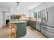 Bright kitchen featuring white cabinets, stainless steel appliances, granite counters, and a center island at 815 Lake Forest Pass, Roswell, GA 30076