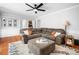 Open-concept living room with hardwood floors and wet bar with a large sectional sofa at 815 Lake Forest Pass, Roswell, GA 30076