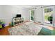 Spacious playroom with great natural light, shelving, and a comfortable rug for to enjoy at 815 Lake Forest Pass, Roswell, GA 30076