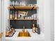 Stylish wet bar with custom cabinets, open shelving, and a gold sink at 815 Lake Forest Pass, Roswell, GA 30076