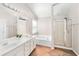 Bright bathroom featuring double sinks, a soaking tub, and a glass-enclosed shower, creating a spa-like retreat at 103 Harvest Rdg, Acworth, GA 30102