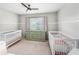 Bedroom featuring two cribs, a dresser, and plenty of natural light at 103 Harvest Rdg, Acworth, GA 30102