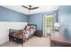 Bright bedroom features wood trim, a ceiling fan, and a colorful comforter at 103 Harvest Rdg, Acworth, GA 30102
