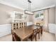 Dining room with a large window, modern light fixture, and a wooden table with seating for six at 103 Harvest Rdg, Acworth, GA 30102