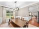 Dining room featuring wainscoting, a stylish light fixture, and a table with seating for six at 103 Harvest Rdg, Acworth, GA 30102