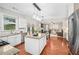 Bright kitchen features granite countertops, stainless steel appliances, and an island with pendant lighting at 103 Harvest Rdg, Acworth, GA 30102