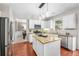 Stylish eat-in kitchen featuring stainless appliances, granite counters, and wood floors at 103 Harvest Rdg, Acworth, GA 30102