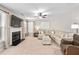 Bright living room featuring plush seating, a fireplace, and a ceiling fan at 103 Harvest Rdg, Acworth, GA 30102