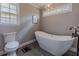 Bathroom boasts a modern soaking tub, stylish fixtures, and unique windows at 130 Brandon Mill Cir, Fayetteville, GA 30214