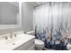 Bathroom features decorative shower curtain, framed mirror, and single vanity at 130 Brandon Mill Cir, Fayetteville, GA 30214