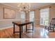 Elegant dining room featuring hardwood floors, a modern light fixture, and large windows with natural light at 130 Brandon Mill Cir, Fayetteville, GA 30214