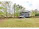 Exterior back view of home with deck and expansive lawn at 130 Brandon Mill Cir, Fayetteville, GA 30214