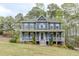 Charming two-story home featuring a covered front porch, classic siding, and beautifully landscaped front yard at 130 Brandon Mill Cir, Fayetteville, GA 30214