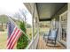 Charming front porch with rocking chairs and American flag at 130 Brandon Mill Cir, Fayetteville, GA 30214