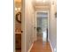 Hallway with hardwood floors and access to a half bathroom and a view to the backyard at 130 Brandon Mill Cir, Fayetteville, GA 30214