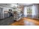Bright kitchen with stainless appliances, an island with seating, and hardwood and tile flooring at 130 Brandon Mill Cir, Fayetteville, GA 30214