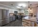 Charming kitchen features gray and white cabinets, stainless steel appliances, and a spacious countertop for dining at 130 Brandon Mill Cir, Fayetteville, GA 30214