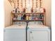 Practical laundry room with washer, dryer, and shelving for storage at 130 Brandon Mill Cir, Fayetteville, GA 30214