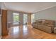 Comfortable living room with hardwood floors, a cozy sofa, and natural light filtering through the windows at 130 Brandon Mill Cir, Fayetteville, GA 30214