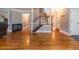 Spacious living room featuring hardwood floors, staircase, and plenty of natural light at 130 Brandon Mill Cir, Fayetteville, GA 30214