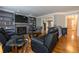 Cozy living room with hardwood floors, a fireplace, custom built-ins, and comfortable seating at 130 Brandon Mill Cir, Fayetteville, GA 30214