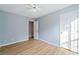 Bedroom with a ceiling fan, hardwood floors, and a double-door closet for ample storage at 2114 Lindley Nw Ln, Kennesaw, GA 30144