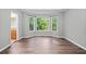 A Primary bedroom with an ensuite bathroom and a bay window overlooking lush greenery at 2114 Lindley Nw Ln, Kennesaw, GA 30144