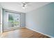 Cozy bedroom with a ceiling fan, light blue walls, and a bright window for natural light at 2114 Lindley Nw Ln, Kennesaw, GA 30144