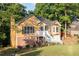 Delightful two-story home with a brick foundation, white stairs, and a beautifully landscaped front yard at 2114 Lindley Nw Ln, Kennesaw, GA 30144
