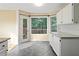 Charming breakfast nook area with white cabinets, granite countertops, and access to the deck at 2114 Lindley Nw Ln, Kennesaw, GA 30144