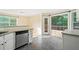 Cozy kitchen with stainless steel dishwasher and granite countertops and a view to the outside deck at 2114 Lindley Nw Ln, Kennesaw, GA 30144