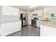 Bright kitchen with white cabinets, stainless steel appliances, and granite countertops at 2114 Lindley Nw Ln, Kennesaw, GA 30144