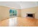 Inviting living room with a brick fireplace, hardwood floors, and a large window at 2114 Lindley Nw Ln, Kennesaw, GA 30144