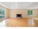 Sunny living area featuring a brick fireplace, hardwood floors, and ample natural light at 2114 Lindley Nw Ln, Kennesaw, GA 30144