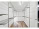 Spacious walk-in closet with multiple shelves and ample storage space, and light wood floors at 2114 Lindley Nw Ln, Kennesaw, GA 30144