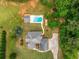 Aerial view of home featuring inground pool, shed and manicured lawn and concrete driveway at 300 Massengale Rd, Brooks, GA 30205