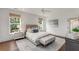Bedroom with an upholstered bed, a gray patterned rug, and three large windows at 300 Massengale Rd, Brooks, GA 30205