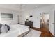 Bright bedroom featuring dark hardwood floors and a large bed with a tufted headboard at 300 Massengale Rd, Brooks, GA 30205