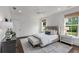 Bright bedroom featuring dark hardwood floors and a large bed with a tufted headboard at 300 Massengale Rd, Brooks, GA 30205