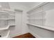 Walk-in closet with white shelves and steel rails at 300 Massengale Rd, Brooks, GA 30205