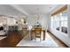 Bright dining room features hardwood floors, white walls, stylish chandelier, and large windows with natural light at 300 Massengale Rd, Brooks, GA 30205