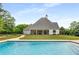 Beautiful backyard with a swimming pool and a covered patio in the background at 300 Massengale Rd, Brooks, GA 30205