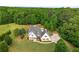 Traditional home with symmetrical design, white exterior, shutters and a well-manicured lawn at 300 Massengale Rd, Brooks, GA 30205